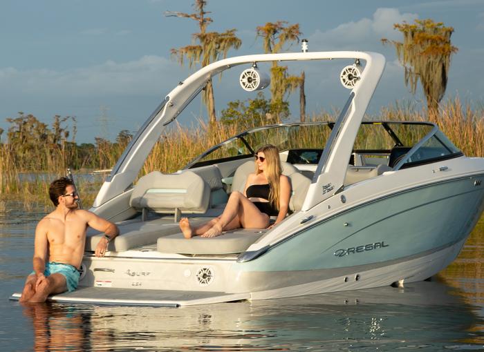 Couple enjoying a evening on the water in their Regal LS4 Surf