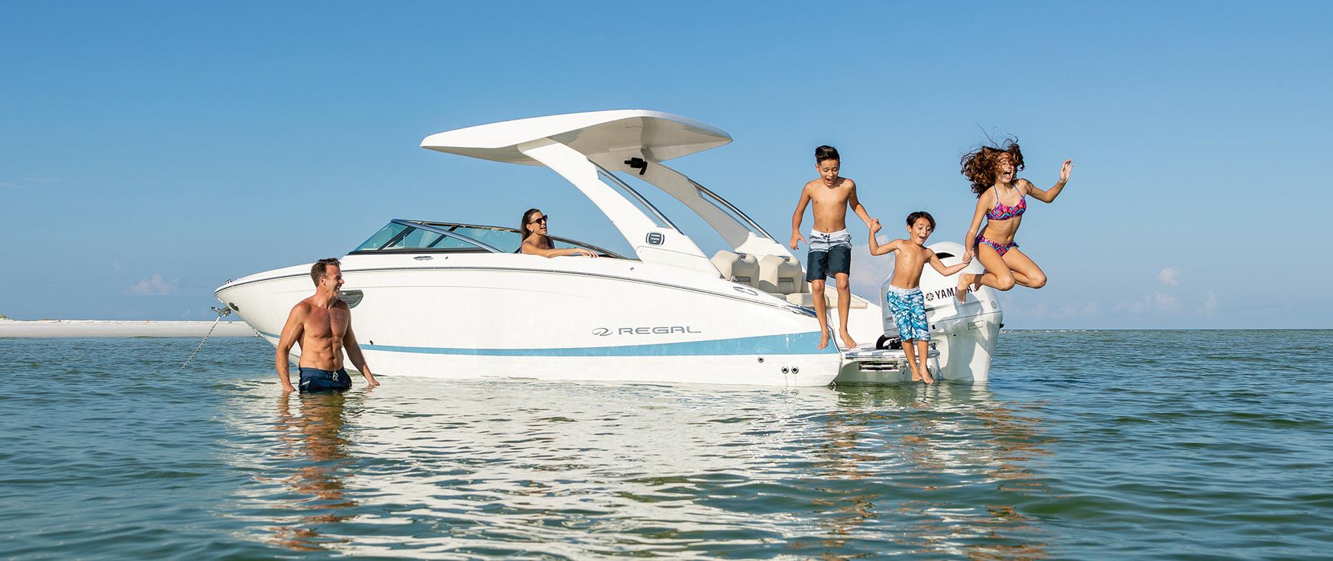 Family jumping off of Regal boat from Port Sandfield marine